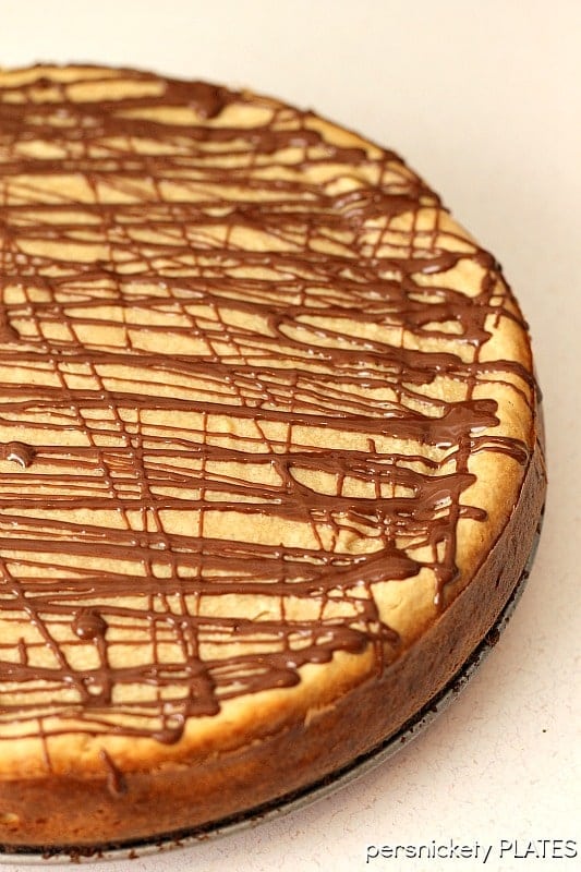 Brownie Bottom Peanut Butter Cheesecake drizzled with chocolate Brownie Bottom Peanut Butter Cheesecake has a layer of chewy brownie topped with a creamy peanut butter cheesecake and drizzled with rich chocolate. | www.persnicketyplates.com #cheesecake #peanutbutter #brownie #dessert