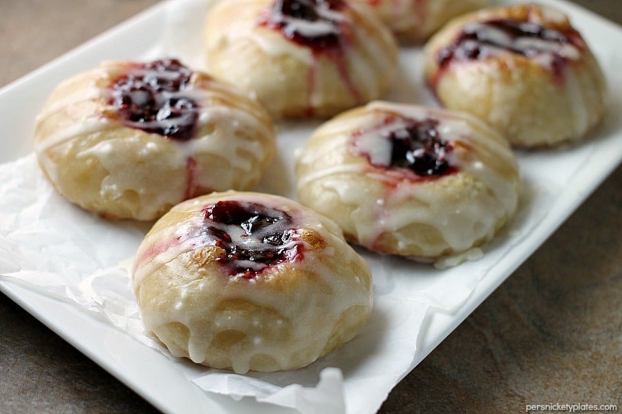 Two ingredients Raspberry Thumbprint Donuts are the perfect breakfast treat. Great to make with your kids! | Persnickety Plates white platter with raspberry thumbprint donuts on it