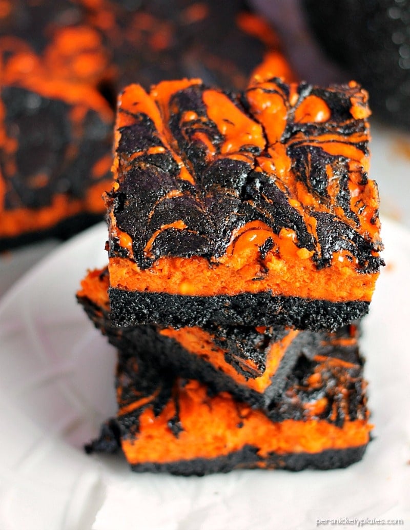 Halloween Cream Cheese Swirl Brownies have a layer of rich, dark chocolate brownie topped with a layer of orange cheesecake then swirled together for a spooky treat. | Persnickety Plates