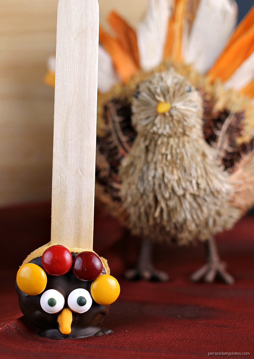 Nilla Wafer Thanksgiving Turkeys are cookies sandwiched together with peanut butter, dipped in chocolate, and decorated with fall colored M&Ms, candy corn, and candy eyes, all on a popsicle stick! So fun for the kids and festive for the Thanksgiving table!