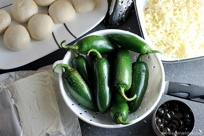 Jalapeno Popper Mummies wrapped in Rhodes bread "bandages" make a spicy and spooky treat for your next Halloween party! | Persnickety Plates