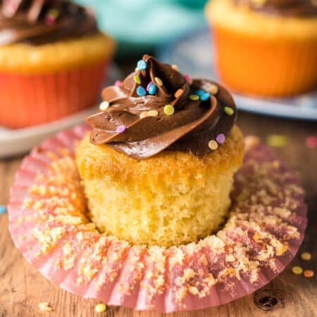a yellow cupcake sitting in a cupcake wrapper.