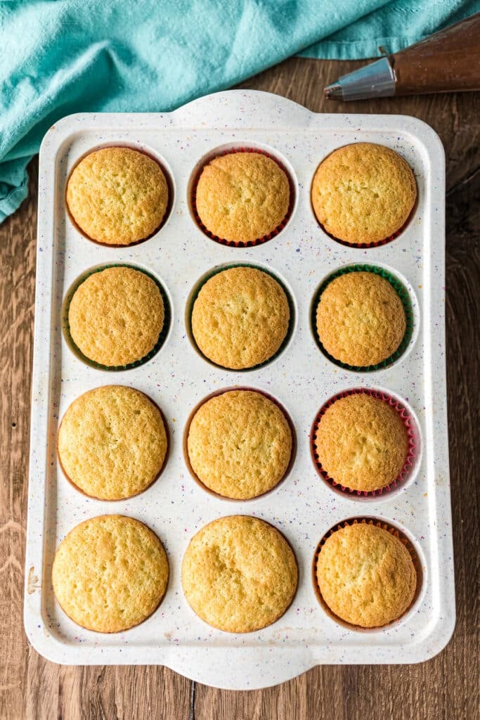 overhead shot of yellow cupcakes in a pan.