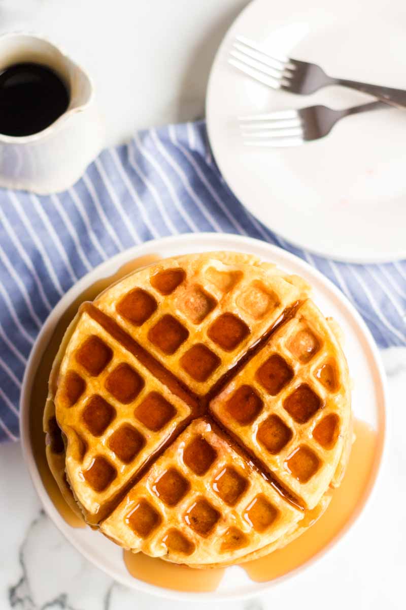 stack of waffles covered in syrup