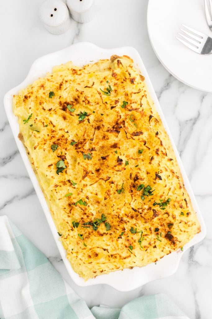 overhead shot of broiled potatoes in a casserole dish
