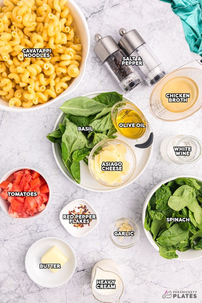 overhead shot of labeled ingredients laid out to make pesto cavatappi.