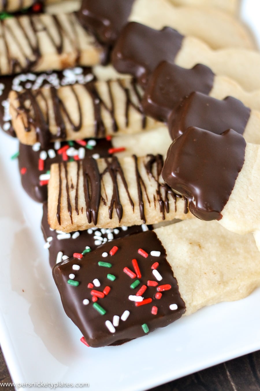 platter of chocolate dipped shortbread cookies with christmas sprinkles