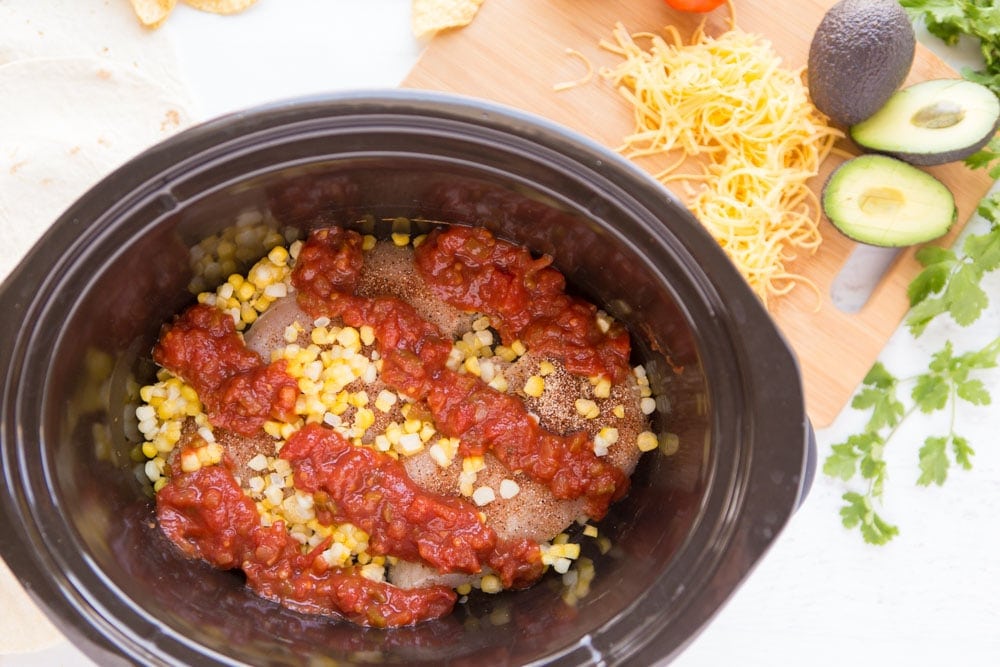 Three ingredient Crock Pot Salsa Chicken is in my regular dinner rotation because it's so easy & so good! Flavorful and versatile, this crockpot chicken breast recipe can be made into burritos, taco bowls, nachos, whatever you feel like!