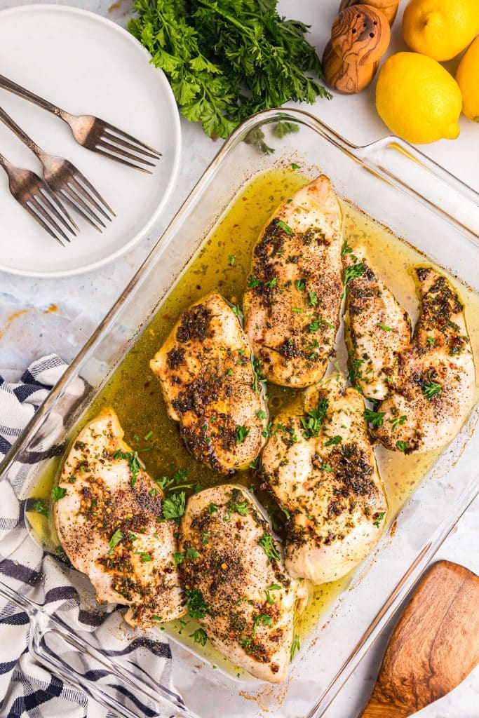 overhead shot of garlic butter chicken in a glass baking dish.