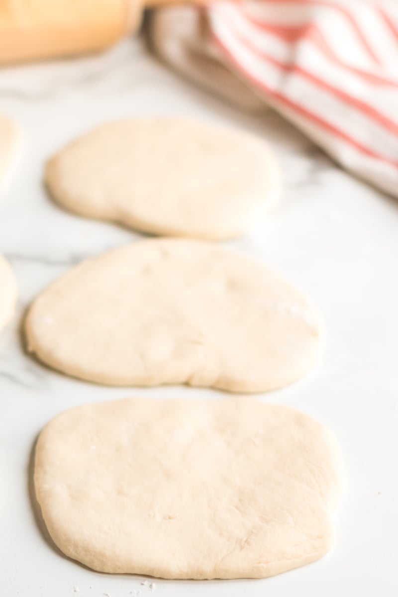 three dough rounds rolled out for homemade pita bread
