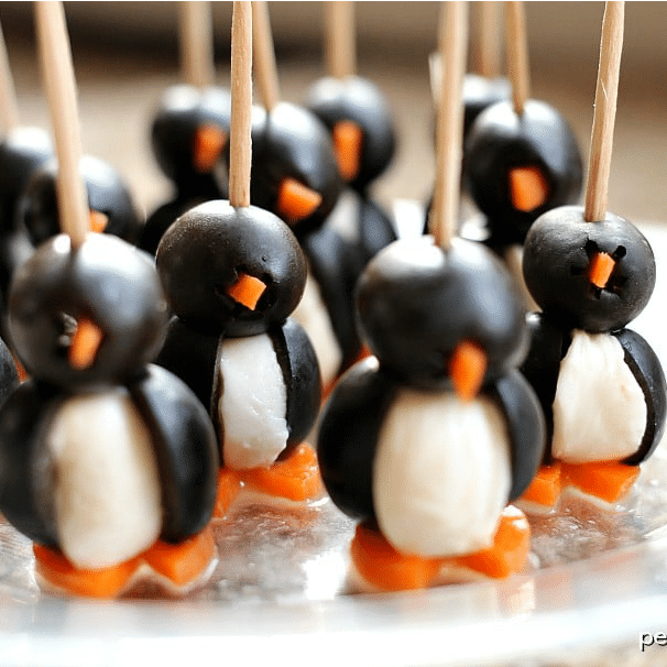 Olive Penguins penguins made out of black olives, mozzarella balls, and carrot feet. Held together with toothpicks.
