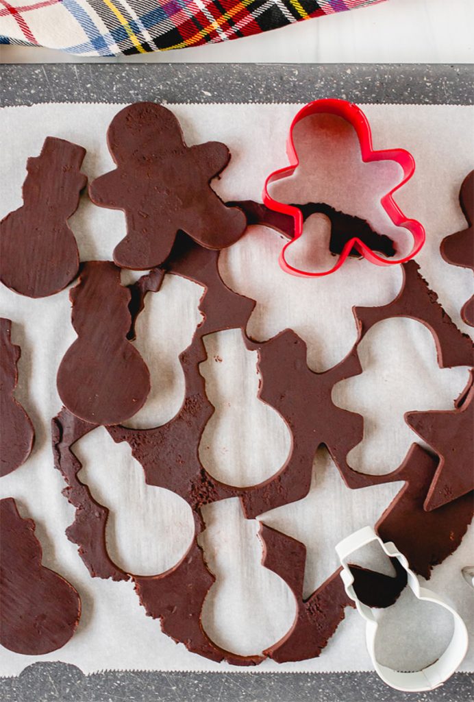 chocolate dough rolled out with cookie cutters