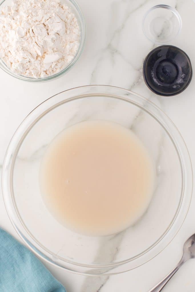 yeast proofing in a glass mixing bowl.