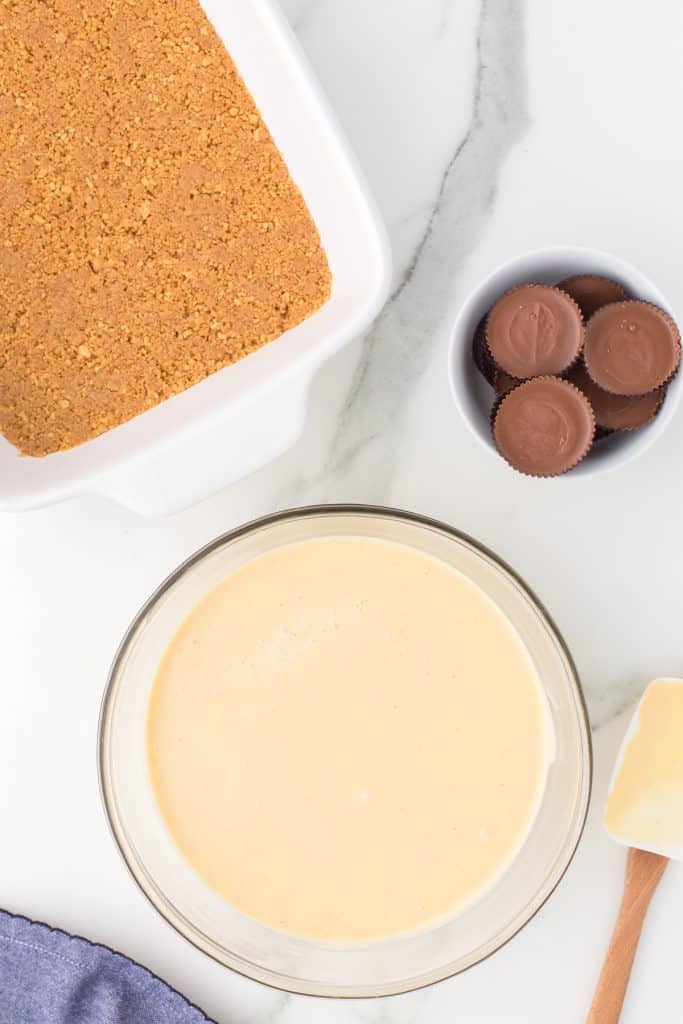 peanut butter cheesecake batter in a glass mixing bowl.
