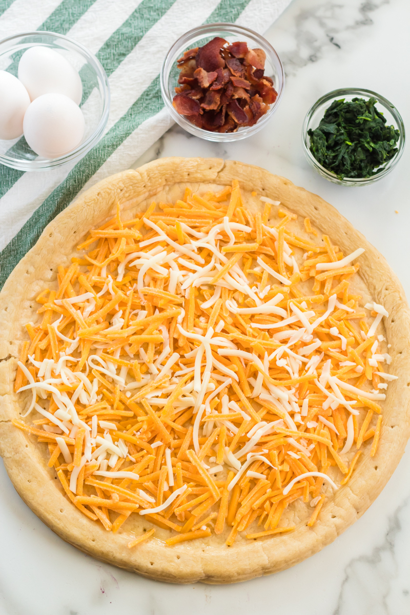 pizza crust covered in shredded cheese