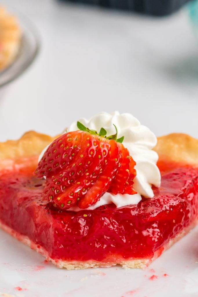 closeup of big boy copycat fresh strawberry pie with a bite missing.