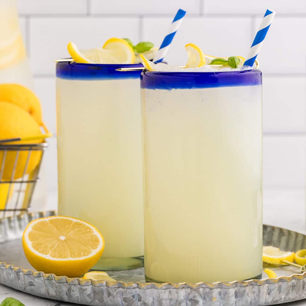 two glasses of frozen lemonade with striped straws.
