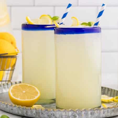 two glasses of frozen lemonade with striped straws.