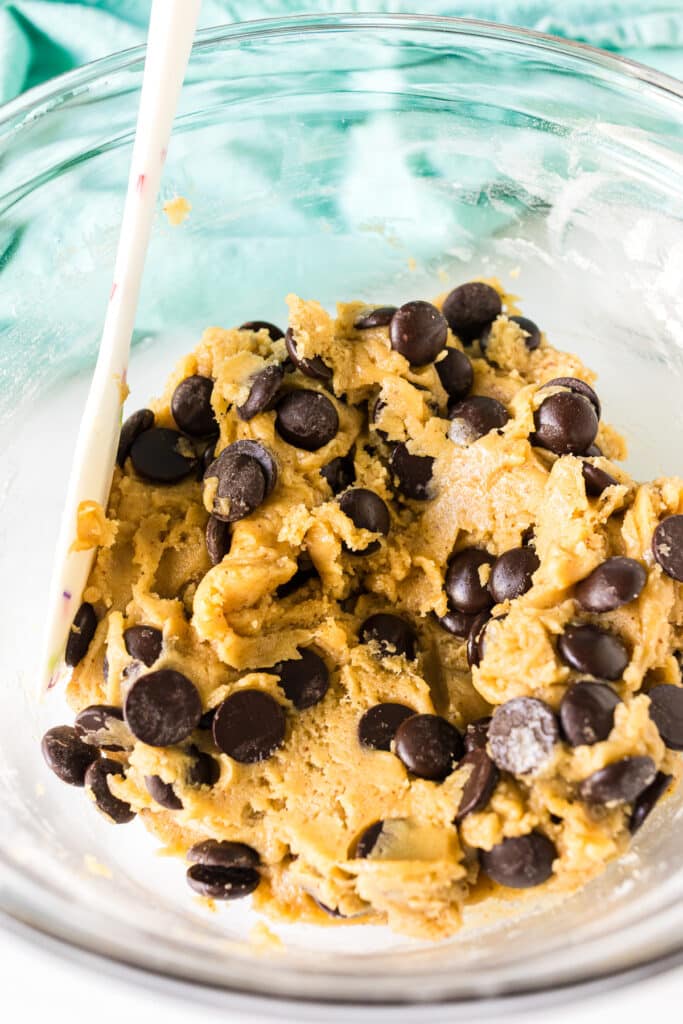 chocolate chip cookie dough in a glass mixing bowl.