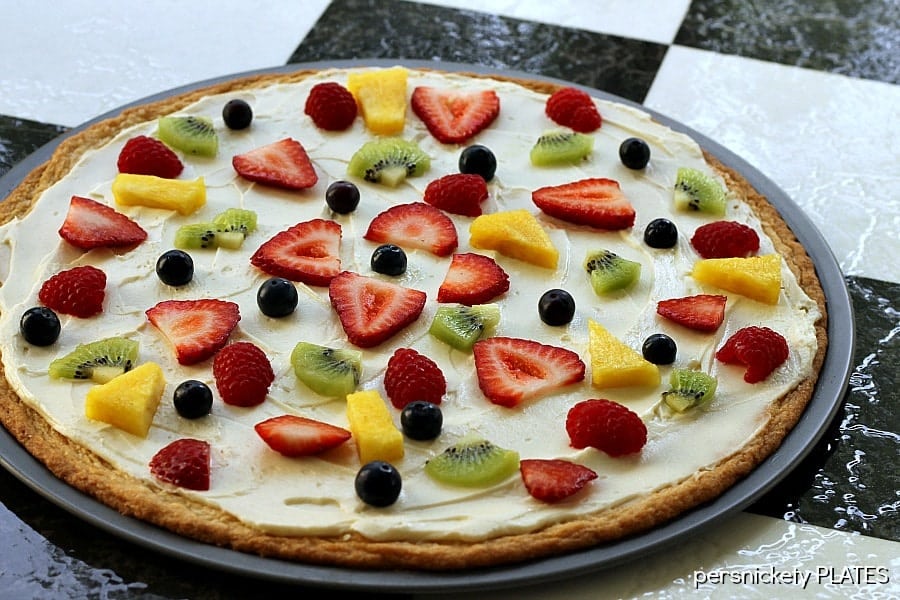 Sugar Cookie Fruit Pizza Sugar Cookie Fruit Pizza -a thin sugar cookie "crust" spread with a cream cheese "sauce" and topped with strawberries, raspberries, kiwi, blueberries, pineapple - whatever fruit you love!