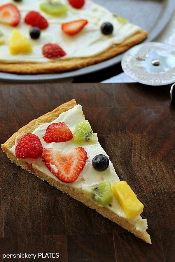 Sugar Cookie Fruit Pizza Sugar Cookie Fruit Pizza -a thin sugar cookie "crust" spread with a cream cheese "sauce" and topped with strawberries, raspberries, kiwi, blueberries, pineapple - whatever fruit you love!