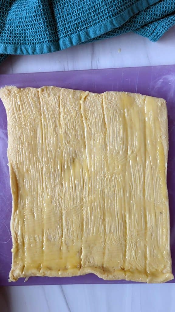 crescent roll dough rolled out and brushed with melted butter.