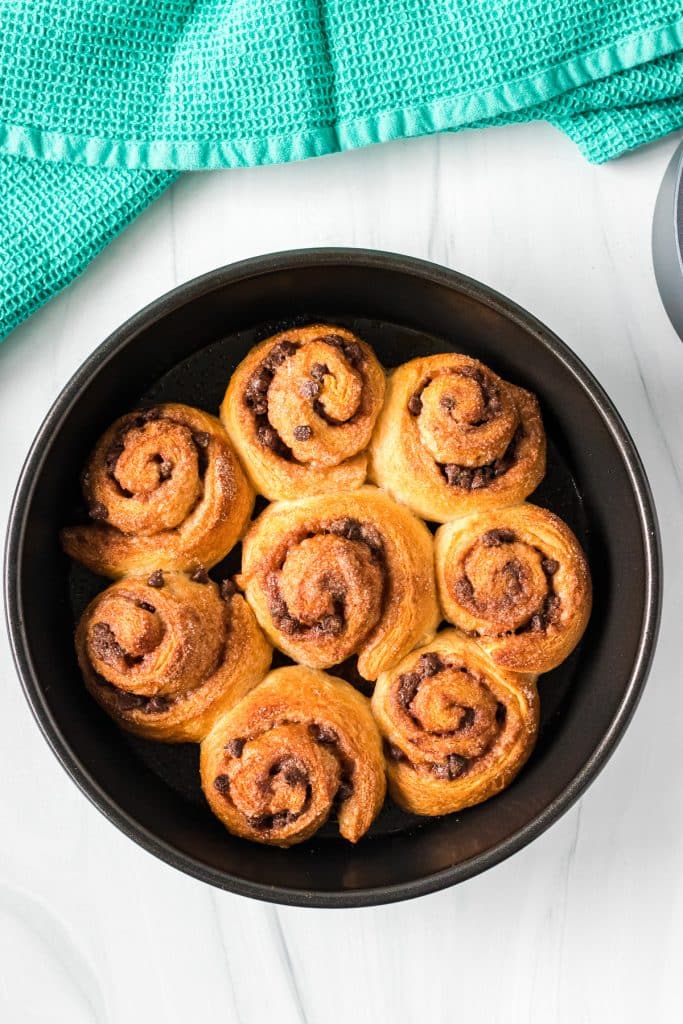 overhead shot of cinnamon rolls in a round baking dish.