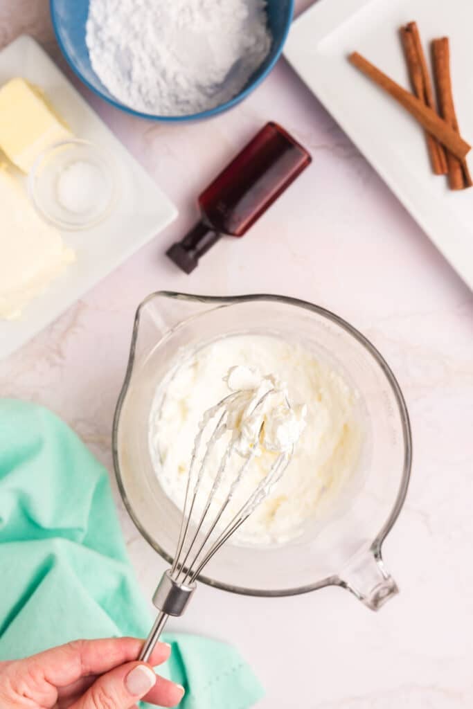 overhead shot of whisk showing homemade whipped cream.