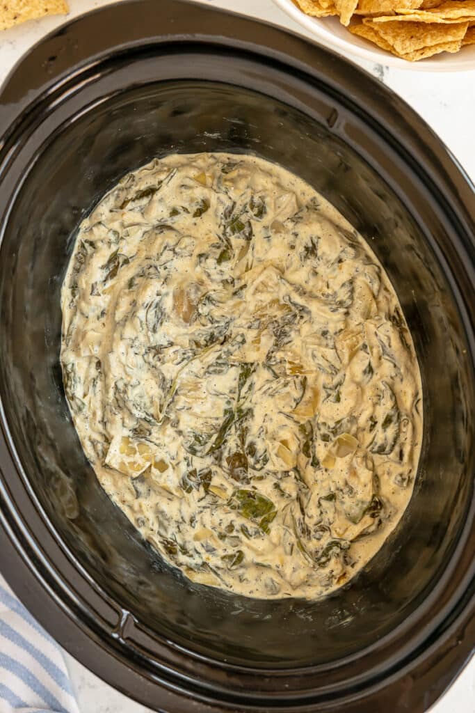 overhead shot of crockpot spinach artichoke dip.