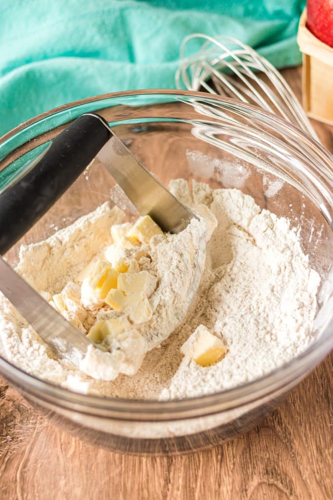 pastry cutter with butter and flour in a mixing bowl.