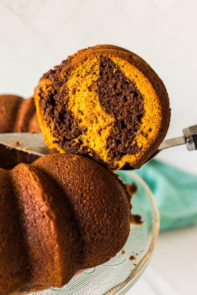 slice of pumpkin marble cake being lifted from a plate.