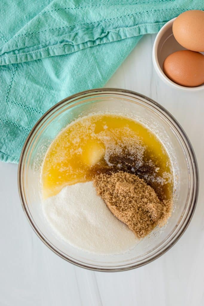melted butter and sugars in a glass mixing bowl.
