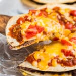 a slice of mexican pizza lifting from the pan.