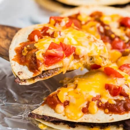 a slice of mexican pizza lifting from the pan.