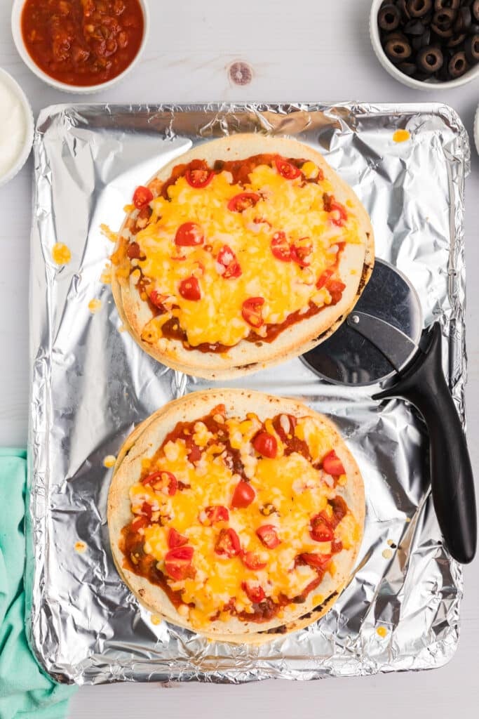 overhead shot of two mexican pizzas on foil.