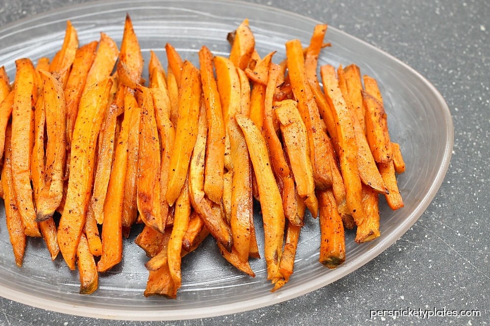 baked sweet potato fries on a plate This March Meal Plan includes easy dinners, sides, and desserts to help you save time and plan ahead. Menu planning made easy with recipes for the month. | www.persnicketyplates.com
