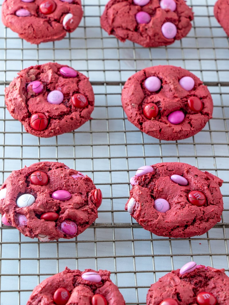 red cookies on a cooling rack
