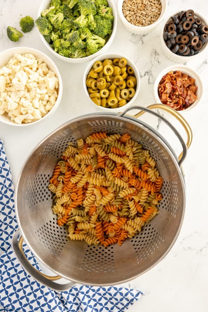 tri-colored rotini in a colander.