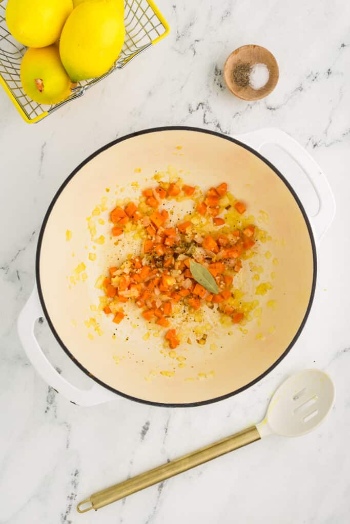sauteed veggies in a soup pot.