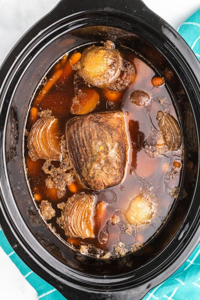 overhead shot of eye of round beef in slow cooker.
