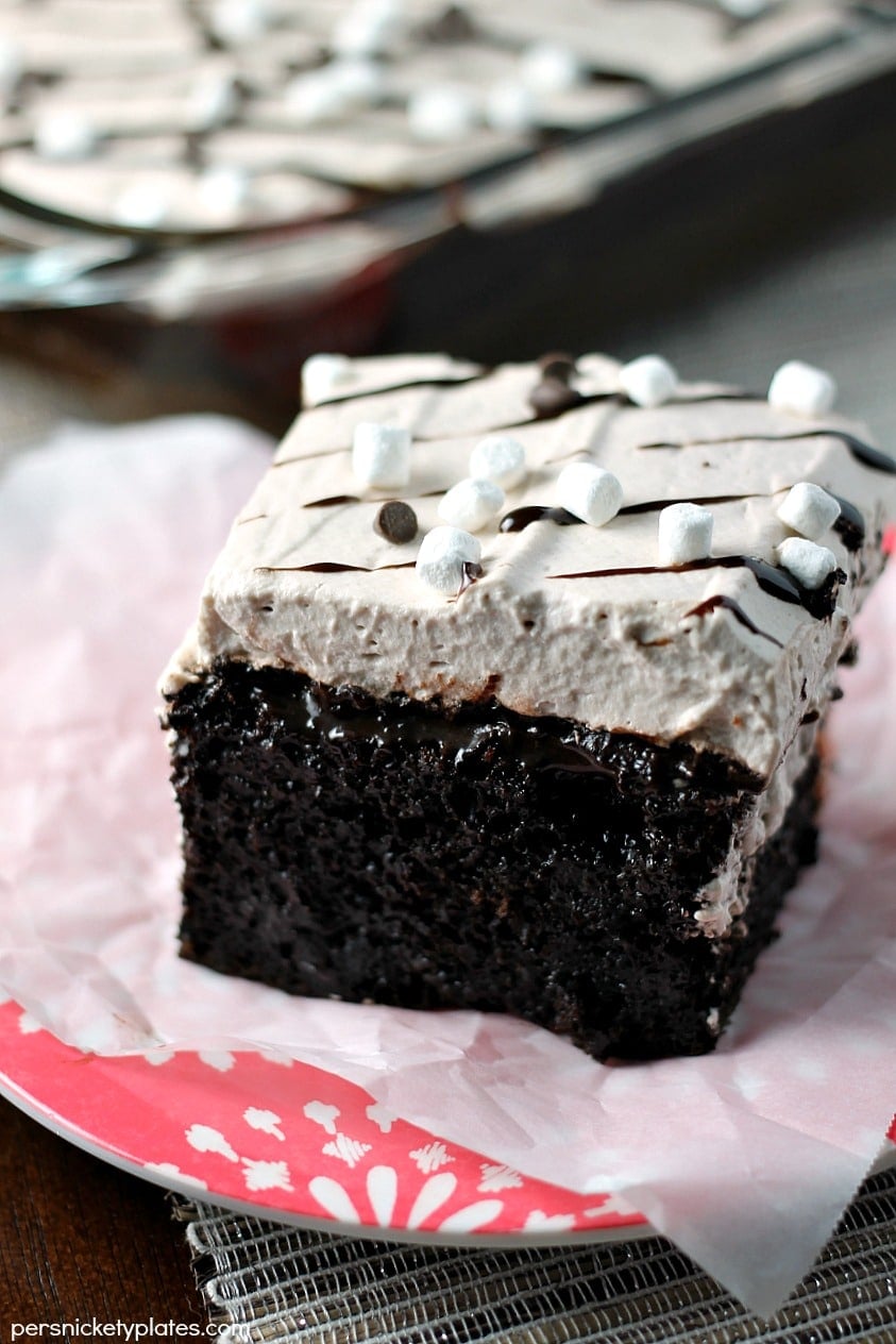 This Hot Chocolate Poke Cake takes everything you love about hot chocolate and puts it into cake form. Perfect for a holiday celebration! | Persnickety Plates