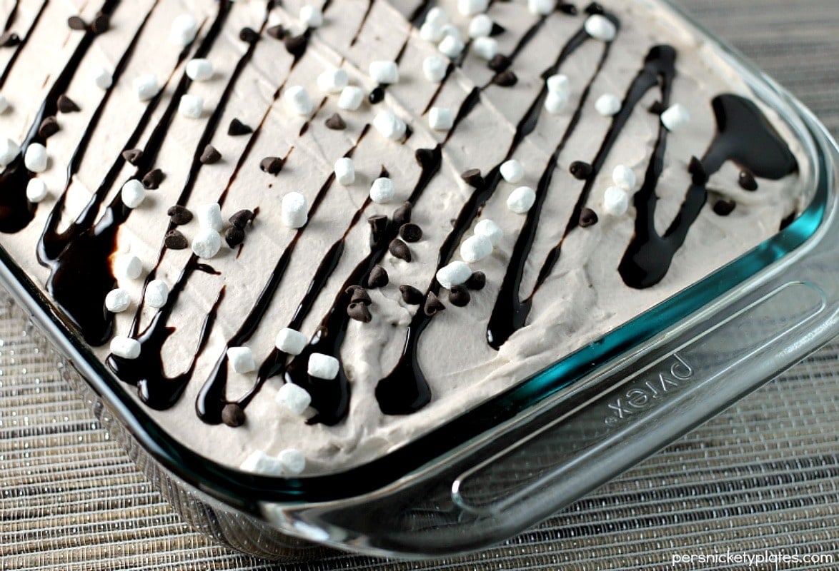 This Hot Chocolate Poke Cake takes everything you love about hot chocolate and puts it into cake form. Perfect for a holiday celebration! | Persnickety Plates