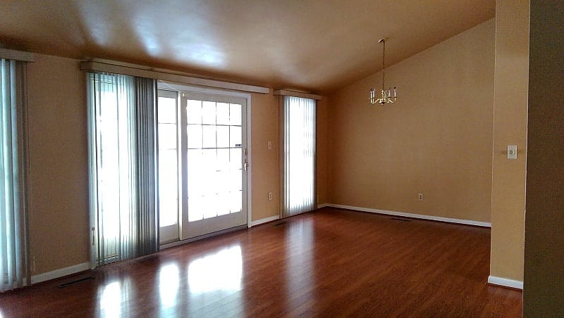 Before and after pictures of our living room/dining room done on a budget. Changing paint makes a huge difference - with Benjamin Moore Stonington Gray & Timber Wolf | Persnickety Plates