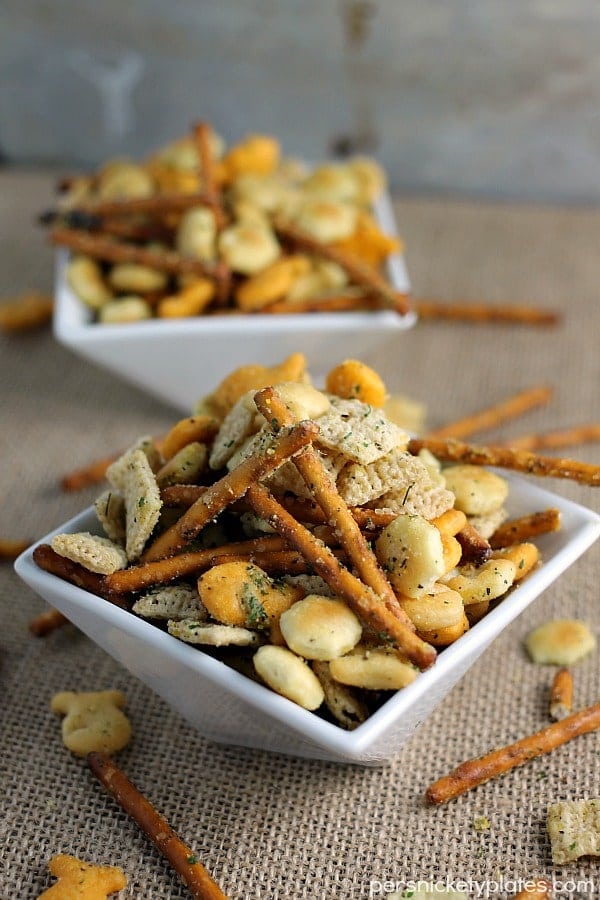 Ranch Cocktail Crackers white bowl filled with pretzel sticks, oyster crackers, chex cereal, and ranch seasoning