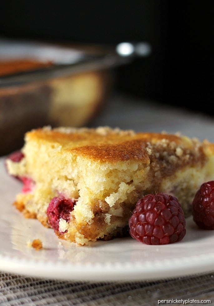 A layer of cake, a layer of raspberries and cream cheese, and a crumb topping come together perfectly in this Raspberry Cream Cheese Coffee Cake. Perfect for Mother's Day! | Persnickety Plates