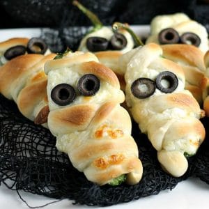 Jalapeno Popper Mummies wrapped in Rhodes bread "bandages" make a spicy and spooky treat for your next Halloween party! | Persnickety Plates