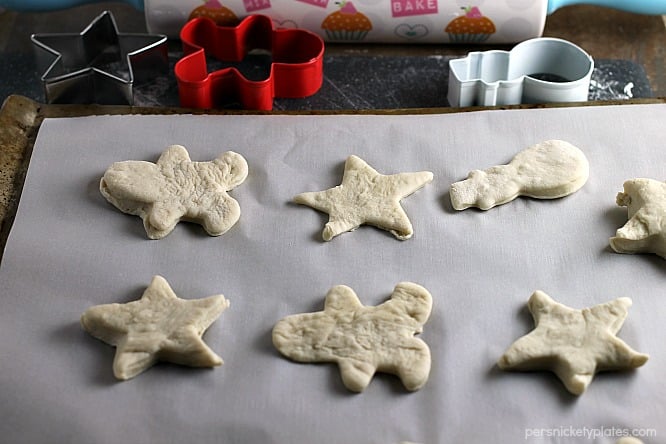 dinner rolls on a baking sheet in christmas shapes