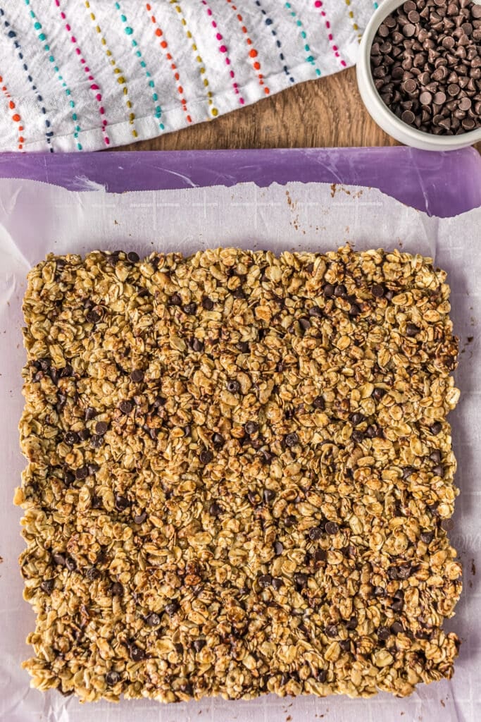overhead shot of square of granola bar on a cutting board.