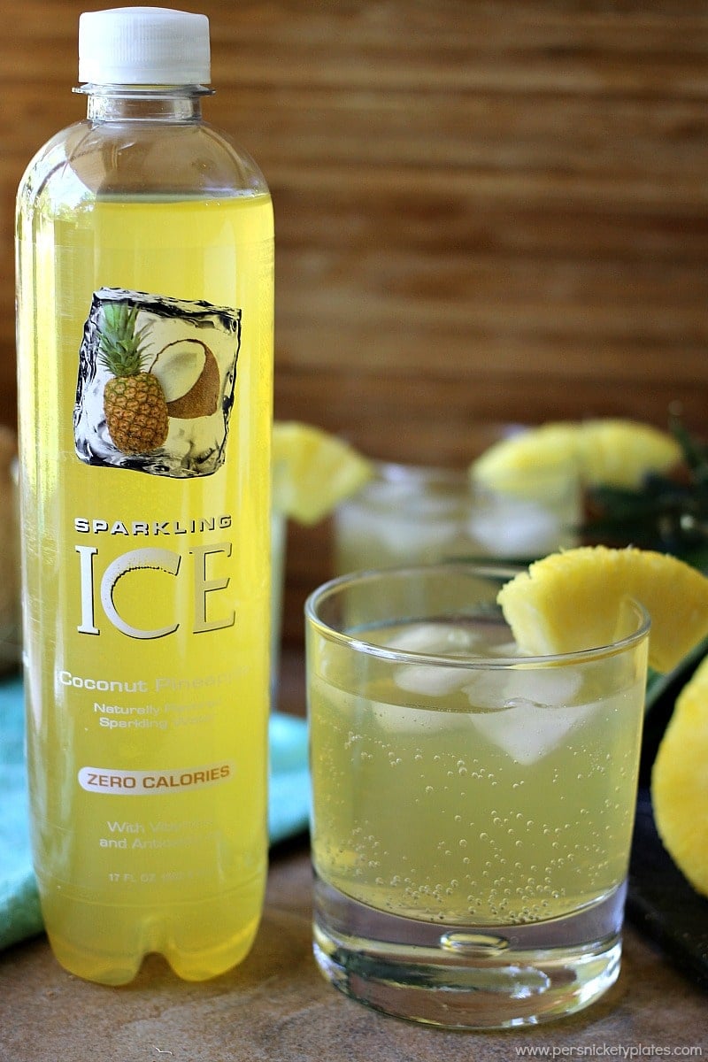 skinny pineapple coconut cocktail next to sparkling ice drink Skinny Pineapple Coconut Cocktail is a fizzy, low calorie drink that is perfect for summertime. | www.persnicketyplates.com