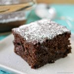 slice of chocolate cake topped with powdered sugar